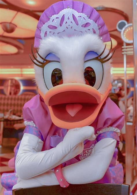 A Person Dressed As A Duck Wearing A Pink Dress