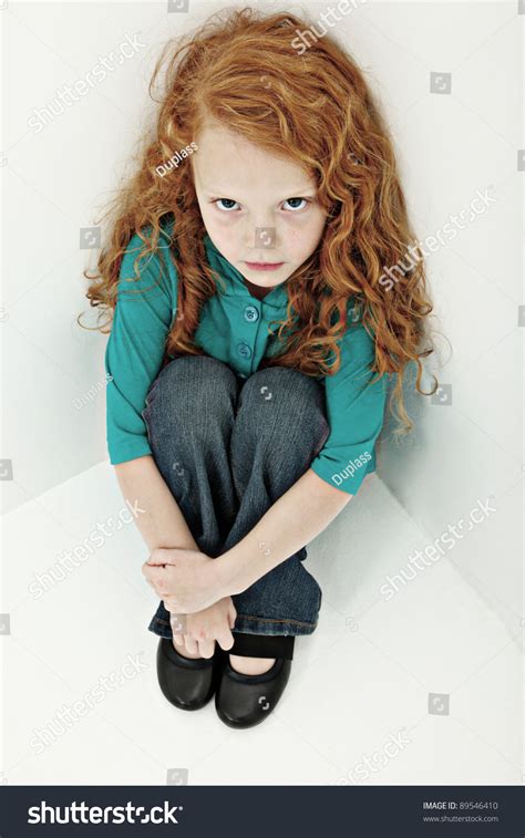 Worried Sad Young Girl Child Sitting Alone In Corner Stock Photo