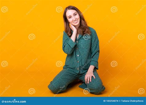 Smiling Young Girl In Pajamas Home Wear Posing While Resting At Home Isolated On Yellow