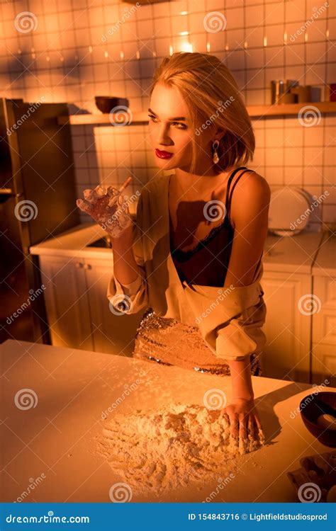 Selective Focus Of Beautiful Housewife Smoking Cigarette While Cooking