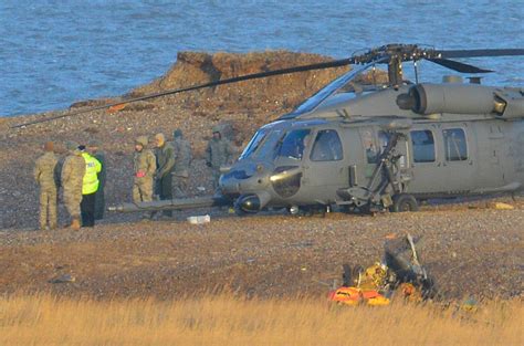 A Pave Hawk Helicopter Military Personnel And Emergency Services Attend The Scene Of A