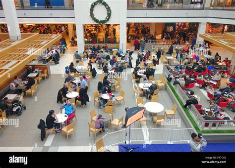 People Sitting At Tables At A Mall Food Court In Toronto Canada Stock