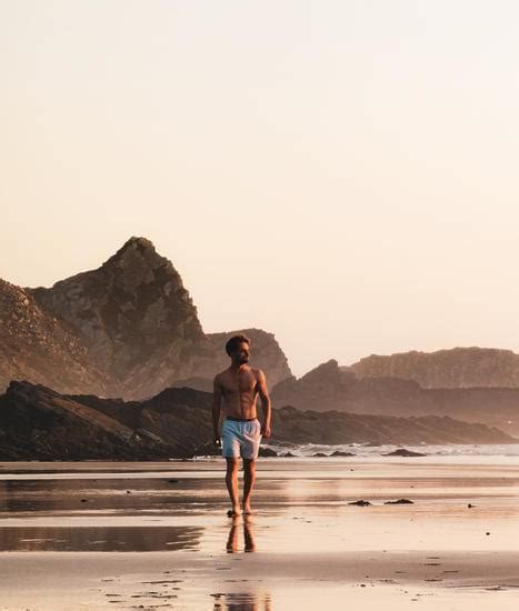 Shirtless Man Walking On Shore Photos By Canva