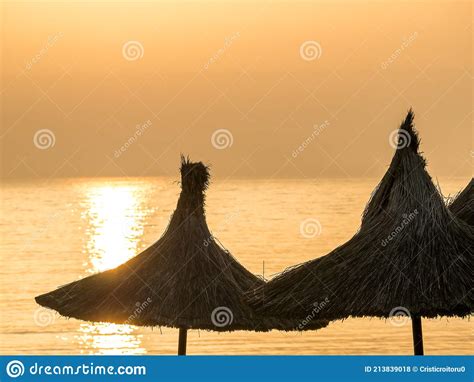Summer Landscape At Sunrise With Straw Umbrellas On The Beach In Mangalia Or Mamaia Beach At