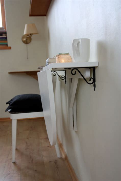 Featuring multiple storage compartments and a drawer. White wall mounted drop leaf table Fold down desk Wall ...