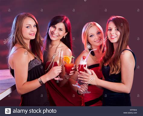 Group Of Four Happy Beautiful Young Female Friends Celebrating In A