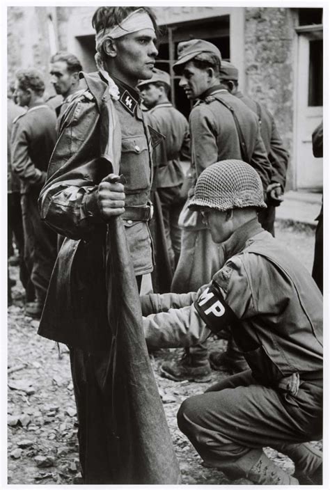 American Military Policeman Searching A Captured German Ss Officer