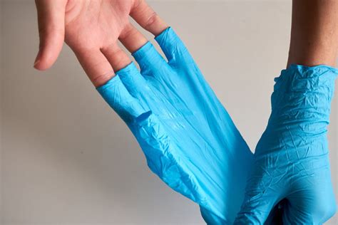 Person Removing Gloves · Free Stock Photo