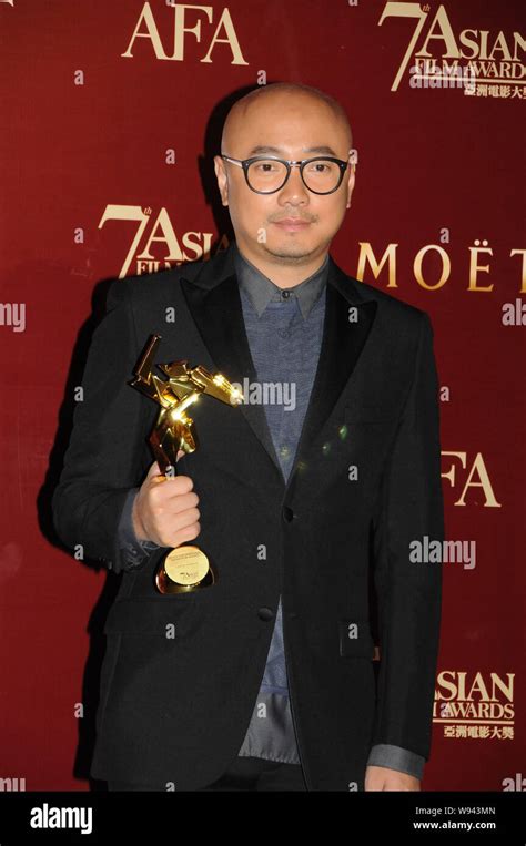 Chinese Actor And Director Xu Zheng Poses With His Trophy After Winning