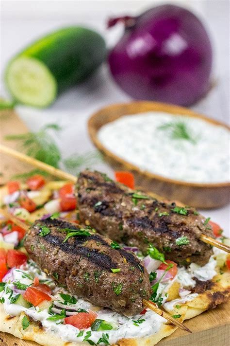 Grilled Beef Kofta Kabobs Served With Grilled Naan And Tzatziki Sauce