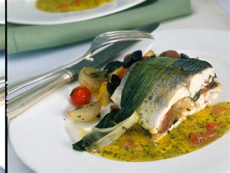 Roasted branzino filets are topped with citrus pesto and a variety of seasonal citrus slices. Ricetta Branzino farcito con salsa all'olio | Donna Moderna