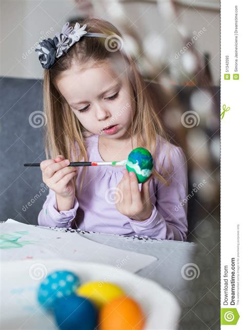 A Happy Little Girl Coloring Easter Eggs Stock Image Image Of House