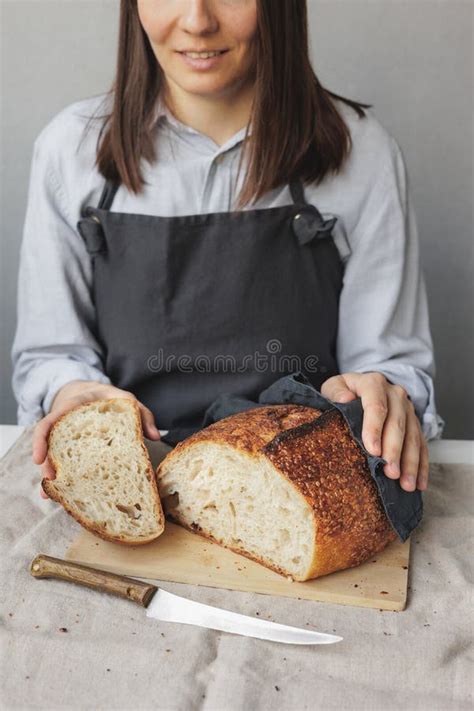 Woman Baker Cooks Bread In The Kitchen A Cook In A Pastry Shop Holds