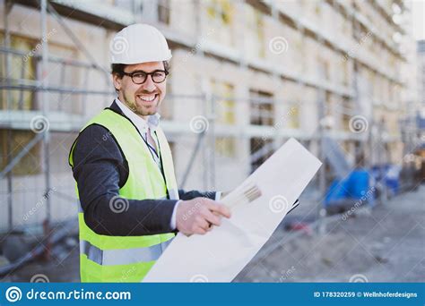 An Architect Civil Engineer At Work On A Construction Site Holding
