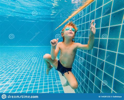 Underwater Young Boy Fun In The Swimming Pool With Goggles Summer