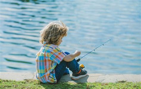 Kids Fisher Child Fishing On The Lake Boy With Spinner At River