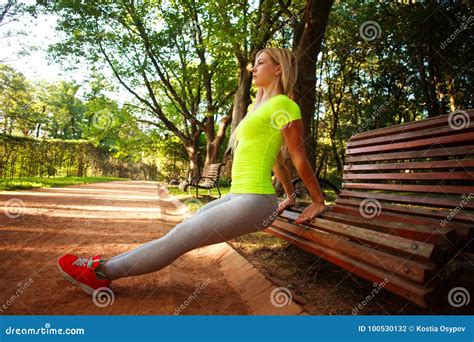 Sporty Slim Woman Doing Push Ups Fitness Exercises In Park Stock Photo
