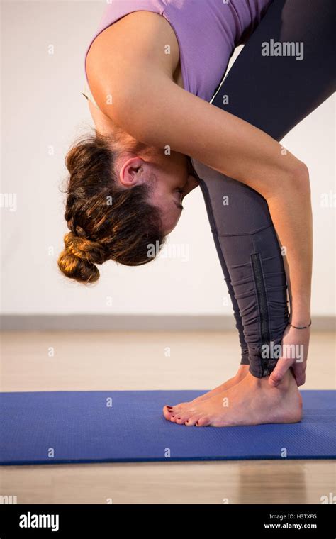 Woman Performing Standing Forward Bend Stock Photo Alamy