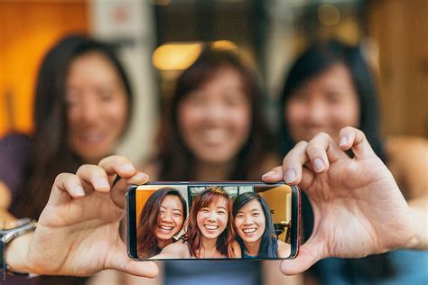 Asian Friends Women Taking A Selfie In The Coffee Shop By Stocksy