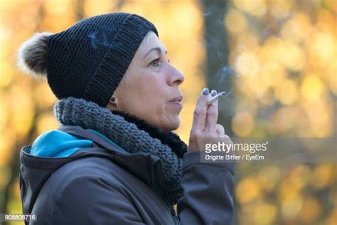 Mature Woman Smoking Cigarette Photos And Premium High Res Pictures
