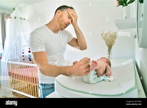 A Father Changing Babys Diaper In Nursery Stock Photo Alamy