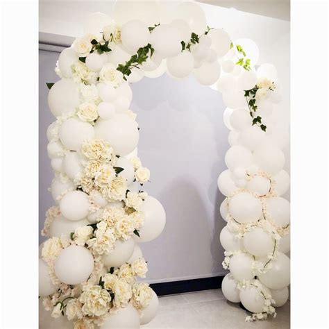 elegant wedding arch with balloons and flowers