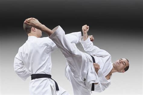 Punch Arm And Kick Leg Athletes Are Beating In Karategi Stock Photo