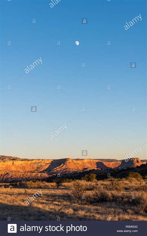 Moon Over A Colorful Desert Landscape At Dusk Over Ghost Ranch In