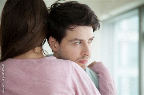Woman Hugging Her Upset Boyfriend Sad Guy Looking Away Through The
