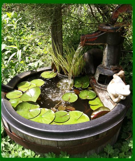 A Fountain And Small Water Garden Made From An Old Whiskey Barrel And