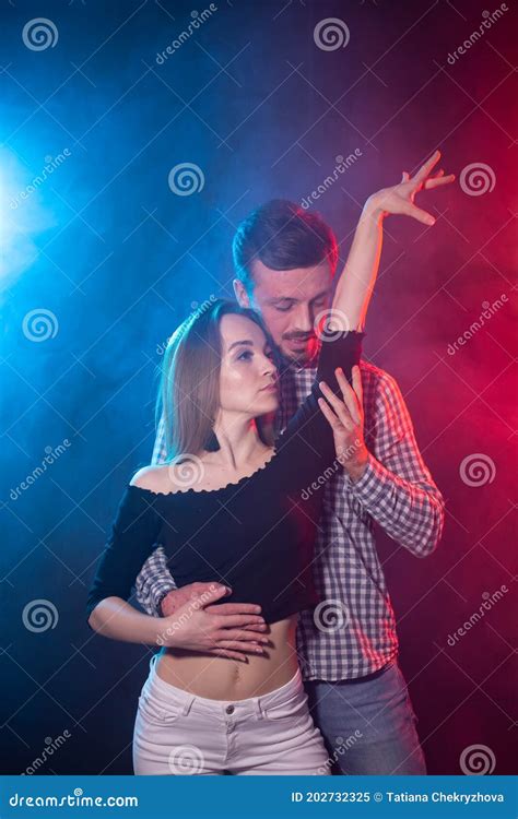 social dance bachata salsa kizomba zouk and tango concept man hugs woman while dancing
