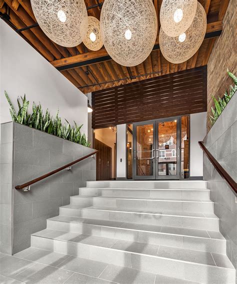 Condo Lobby Redesign With Contemporary Lighting And Reclaimed Wood