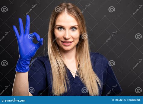 beautiful female dentist wearing scrubs showing ok gesture stock image image of medicine