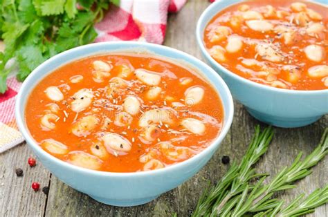 Two Bowls Of Tomato Soup With Pasta White Beans And Rosemary Stock