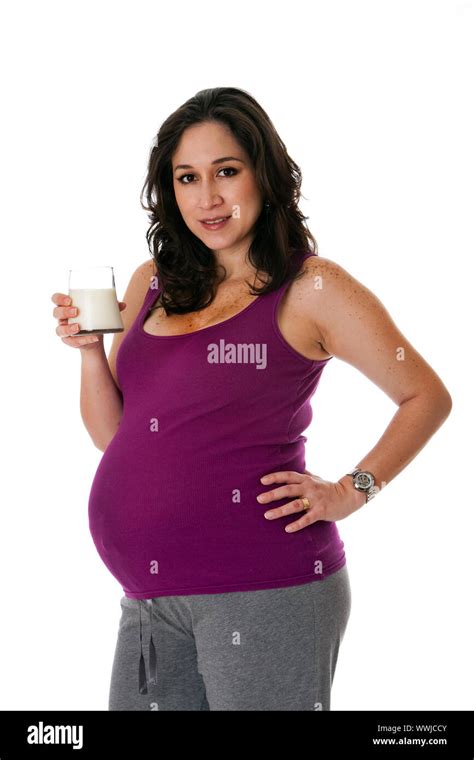 Beautiful Caucasian Pregnant Brunette Woman Holding Glass Of Skim Milk Isolated Hispanic