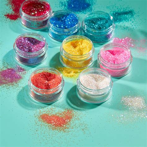 Several Different Colored Glitters Are In Small Jars