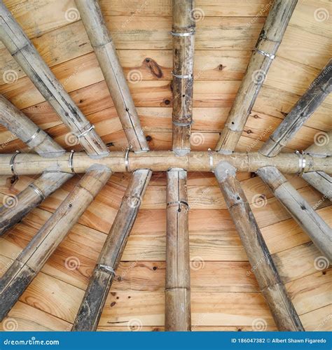Underside Of A Wooden Shingled Roof Supported By Bamboo And Concrete