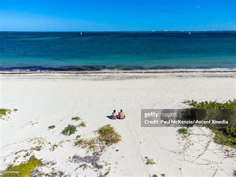 Aerial View Of Couple Relaxing On Tropical Beach High Res Stock Photo