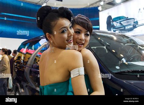 two beautiful asian car models posing for the camera 2008 beijing international automotive