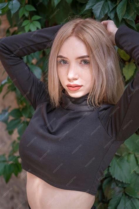 Premium Photo Teenage Girl With Blonde Hair And Red Lips Wears Short Black Turtleneck Put Her