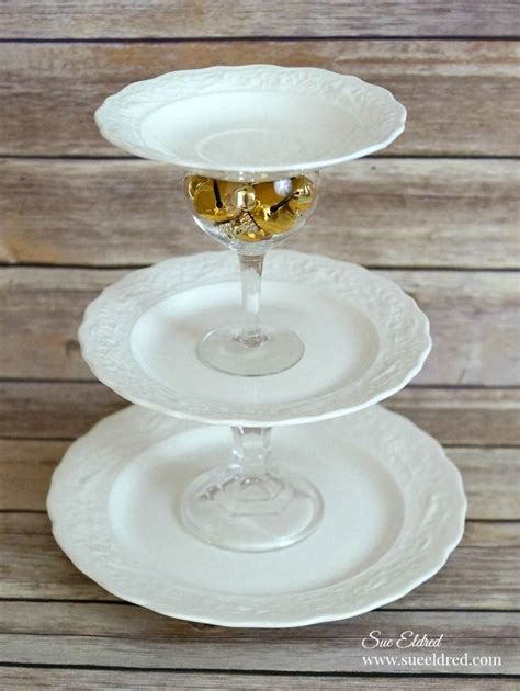 Three White Plates Stacked On Top Of Each Other With Two Glasses Filled