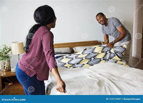 Black Couple Changing Bed Sheet Together Stock Image Image Of Indoor