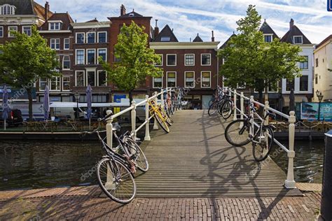 Tour the canals and moats and explore the historic inner city with its beautiful merchant houses and monuments with their wonderful facades. Leiden Holland Netherlands May 2019 Bicycles Parked All ...