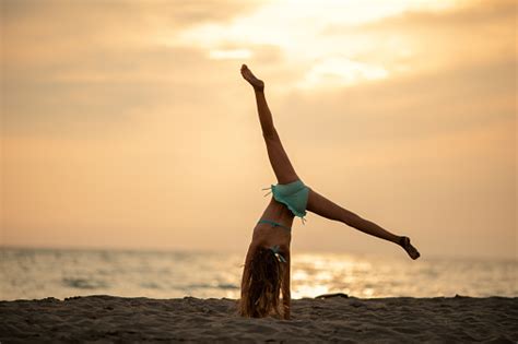 Girl Practicing Handstand On Beach Stock Photo Download Image Now