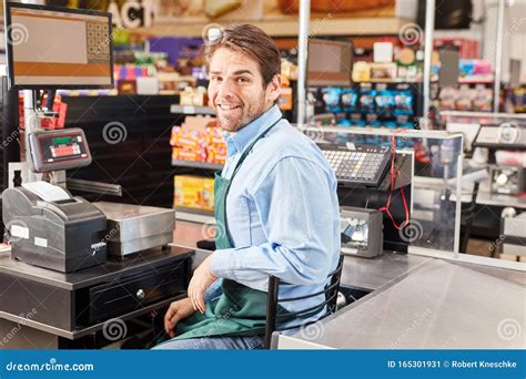 Man As a Cashier Sits at the Cash Register Stock Image - Image of cash