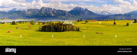 Panoramic Scenery In The Allgäu With Alps And Forggensee Stock Photo
