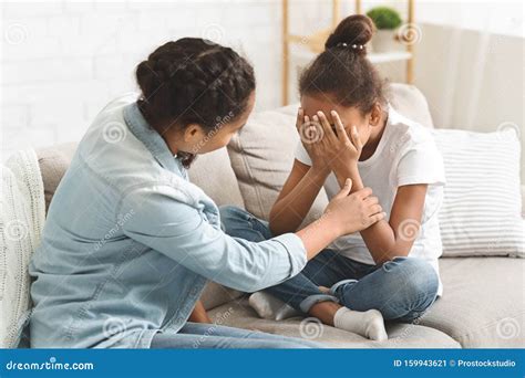 Teenaged Girl Comforting Her Crying Little Sister Stock Image Image