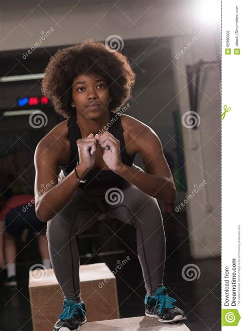 Black Female Athlete Is Performing Box Jumps At Gym Stock
