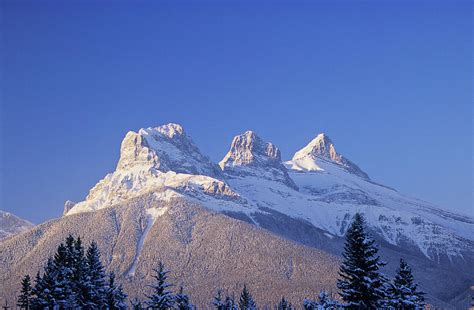 Three Sisters Mountains Canmore By John E Marriott
