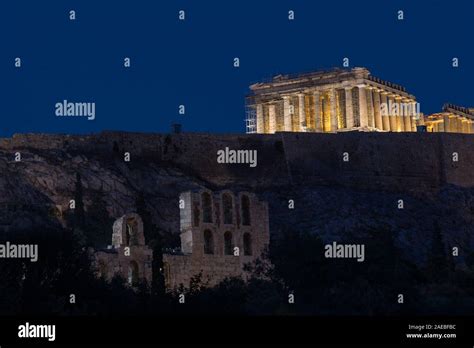 The Parthenon And Acropolis Lit Up At Night With Herodes Theater In The